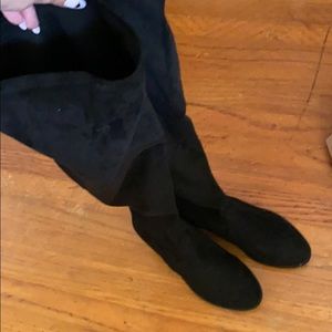 Black thigh high boots in wide calf.